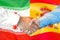 Handshake on Iran and Spain flag background