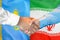 Handshake on Kazakhstan and Iran flag background. Support concept