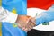 Handshake on Kazakhstan and Iraq flag background. Support concept