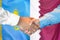 Handshake on Kazakhstan and Qatar flag background. Support concept