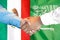 Handshake on Mexico and Saudi Arabia flag background