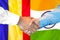 Handshake on Moldova and India flag background