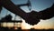 handshake oil contract. handshake a worker and businessman shaking hands against the backdrop of an oil pump. oil