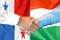 Handshake on Panama and Hungary flag background