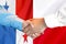 Handshake on Panama and Poland flag background