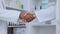 Handshake, partnership and FDA drug approval by pharmacists and healthcare workers in a pharmacy. Chemists shaking hands