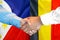 Handshake on Philippines and Belgium flag background