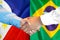 Handshake on Philippines and Brazil flag background