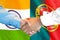 Handshake on Portugal and India flag background