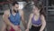 Handshake of sportive young man and woman in gym. Smiling Middle Eastern guy and Caucasian girl sitting in sports club