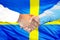 Handshake on Swedish flag background