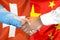 Handshake on Switzerland and China flag background