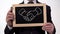 Handshake symbol drawn on blackboard in businessman hands, effective cooperation