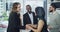 Handshake, teamwork and agreement with businesspeople while supporting contract during a meeting in the boardroom