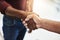 Handshake of two business men and success in an interview. Closeup of diverse males making deal or agreement for a