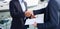 Handshake of two businessmen near the yachts in seaport