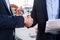 Handshake of two businessmen near the yachts in seaport