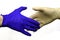 Handshake of two hands in protective hygienic surgical gloves of different colors on the white background