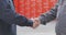 Handshake of two men close-up. Two men shake hands. Factory shaking hands, concluding a successful deal