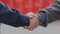 Handshake of two men close-up. Two men shake hands. Factory shaking hands, concluding a successful deal