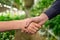 Handshake of two young farmers greeting one another