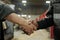 Handshake of two young intercultural workers of factory greeting each other