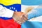 Handshake on Venezuela and Argentina flag background