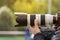 Handshot of a professional photographer outdoors. Man holds a modern camera device. Cameraman shoots outdoors. Shooting with lens.