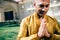 Handsom Indian Man Greeting Namaste in Gold Kurta at the Temple