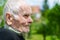 Handsome 80 plus year old senior man posing for a portrait in his garden