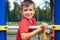 Handsome adorable boy having fun on outdoor playground