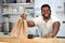 Handsome affable black cafe staff prepared takeaway orders