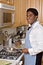 Handsome African-American businessman in kitchen