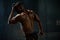 handsome african american male body builder posing on a black studio background. Beauty and perfection of human