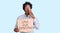 Handsome african american man with afro hair holding save our democracy protest banner covering mouth with hand, shocked and