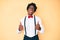 Handsome african american man with afro hair wearing hipster elegant look success sign doing positive gesture with hand, thumbs up