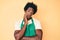 Handsome african american man with afro hair wearing waiter apron thinking looking tired and bored with depression problems with