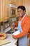 Handsome African-American man cooks in kitchen