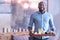 Handsome African American man holding breakfast tray in the bedroom