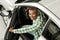 Handsome African man choosing new car at dealership