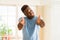 Handsome african young man doing thumbs up gesture, great symbol for succes smiling excited