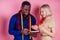 Handsome american businessman seamstress measures a measuring tape female client. tailor,designer and designer