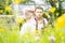 Handsome American WWII GI Army officer in uniform relaxes in a meadow of flowers in front of Willy Jeep