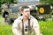 Handsome American WWII GI Army officer in uniform relaxes in a meadow of flowers in front of Willy Jeep