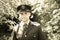 Handsome American WWII GI Army officer in uniform walking through woods