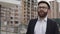 Handsome architect man wearing business suit walks down the construction site. Profession concept.