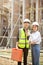Handsome Asian male civil engineer and female architect in the construction site