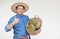 Handsome Asian man farmer wears hat, blue shirt, holds basket of durian fruits