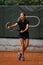 handsome athletic female tennis player with racket and ball prepares to serve at beginning of game