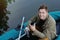 Handsome attractive man on the boat at the lake, lifestyle